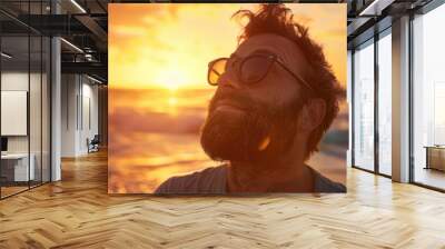 A photographic portrait of a man with sunglasses and a beard, relaxed pose, looking up, medium close-up Wall mural